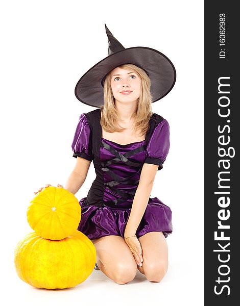 Blonde witch sitting on a pumpkin, holding a pumpkin