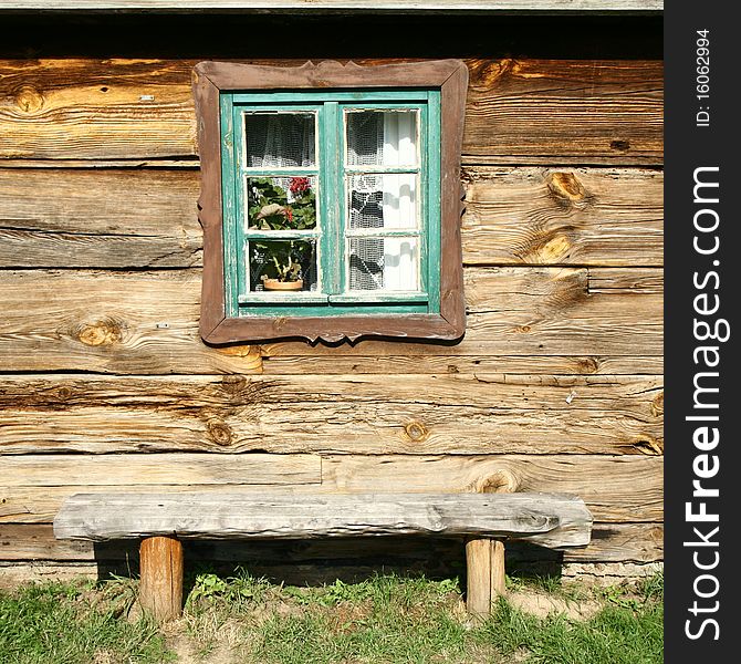 Window of an ancient wooden house and a bench beneath it, europe. Window of an ancient wooden house and a bench beneath it, europe