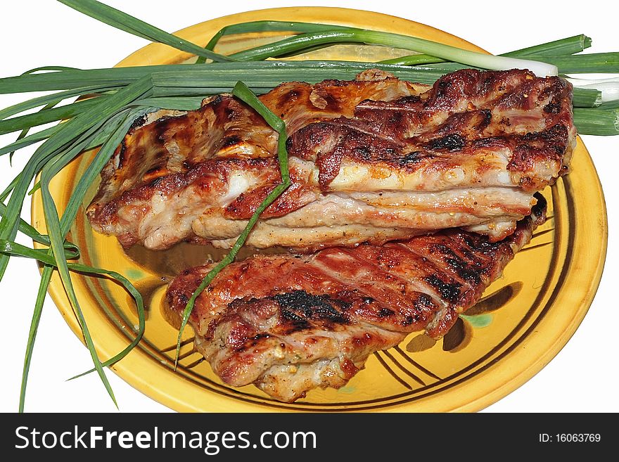 Meat, fried on a barbecue and green onions. Meat, fried on a barbecue and green onions