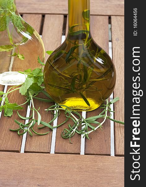 Vinegar and olive oil with herbs in a bottle. Vinegar and olive oil with herbs in a bottle