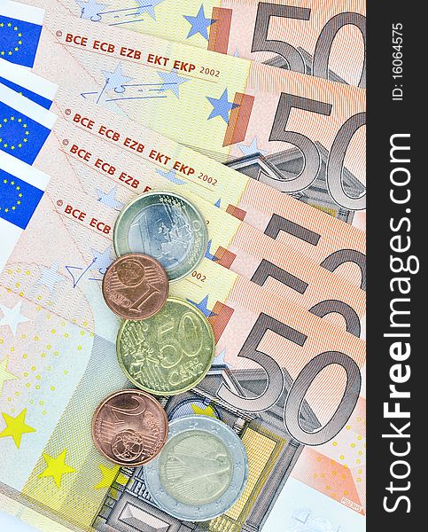 Closeup of fifty euro banknotes with coins. Closeup of fifty euro banknotes with coins