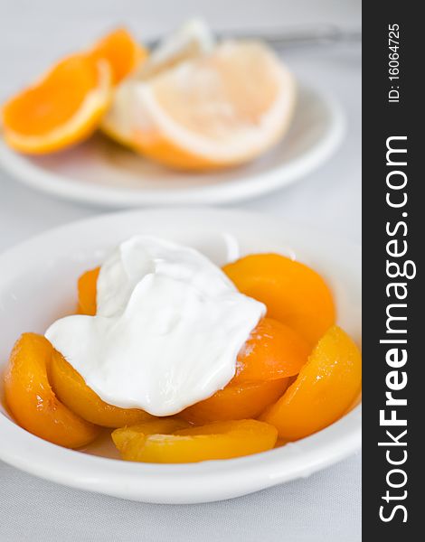 Preserved apricots with sour cream and citrus fruits