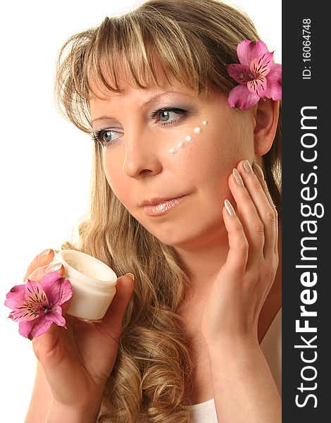 Beautiful adult woman applying cream on her face. Beautiful adult woman applying cream on her face