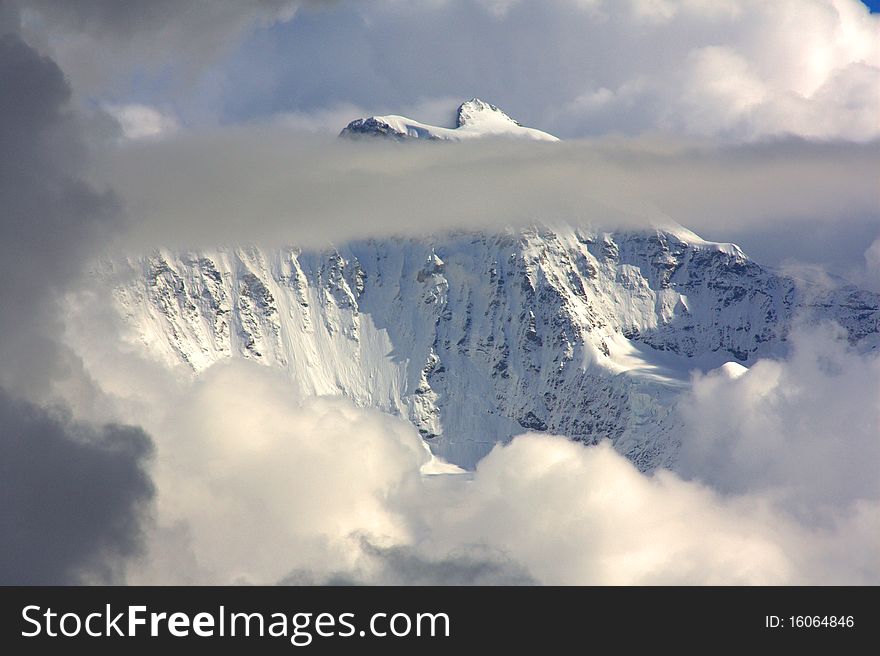 Snowy Mountain Top With Clouds