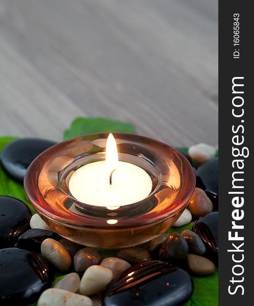 Burning candle with stones and petal. Burning candle with stones and petal