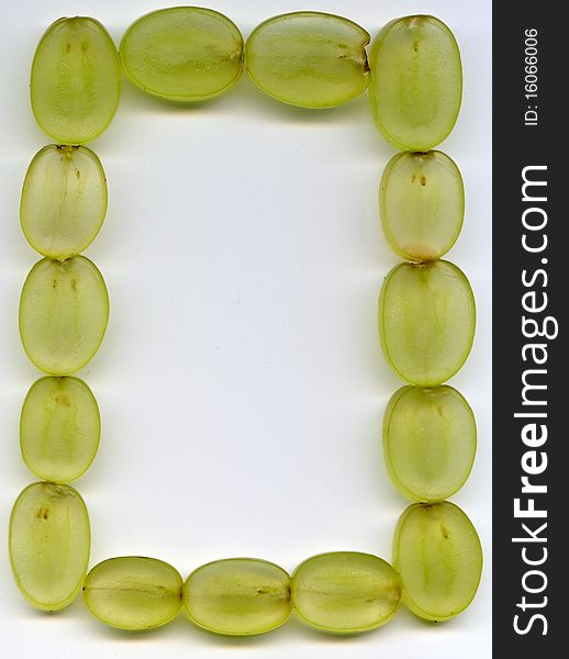 Frame of the sliced green grape on the white background. Frame of the sliced green grape on the white background