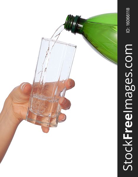 Woman pouring water to a glass from the bottle. Woman pouring water to a glass from the bottle