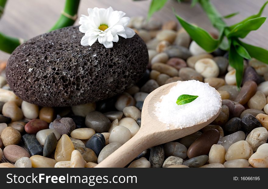 Bath salt on spoon with natural stone