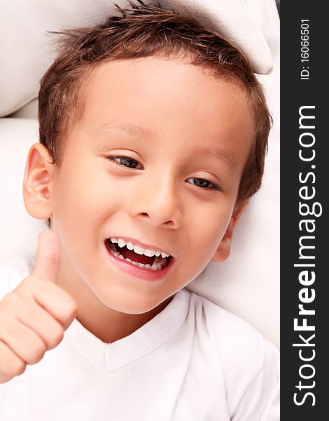 Smiling boy with positive attitude over white background. Smiling boy with positive attitude over white background