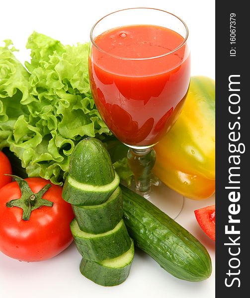 Fresh vegetables and juice on a white background