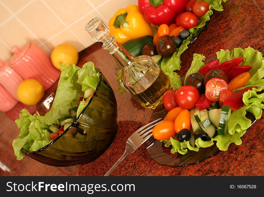 Fresh vegetables and olive oil on a kitchen table. Fresh vegetables and olive oil on a kitchen table