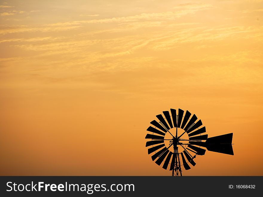 An old windmill at sunset