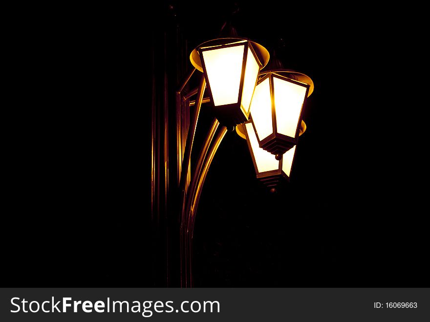 Bronze lantern in park on a black background. Bronze lantern in park on a black background.