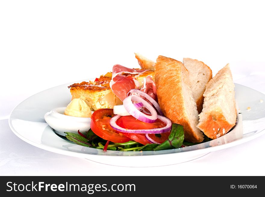 Omelet with salad, bread and cured ham. Omelet with salad, bread and cured ham