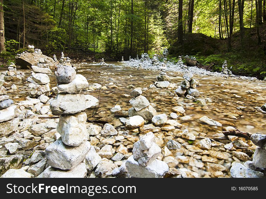 River stream with rocks in forrest.