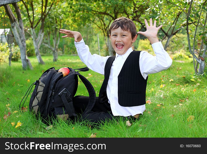 Schoolboy With Backpack And Apple
