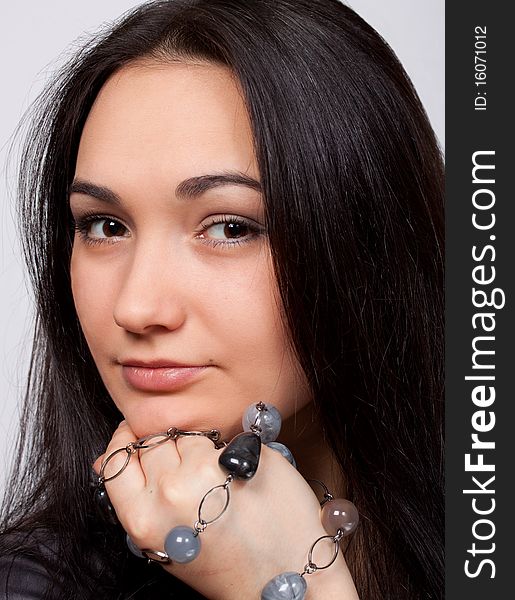 Closeup of attractive brown-eyed girl with glassbeads