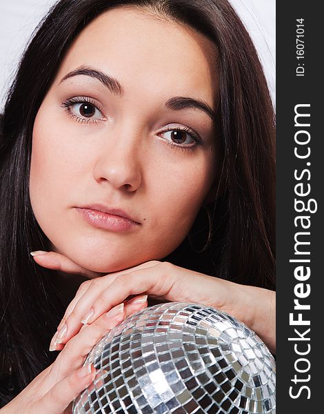 Studio portarait beautiful brown-eyed girl with mirror ball. Studio portarait beautiful brown-eyed girl with mirror ball