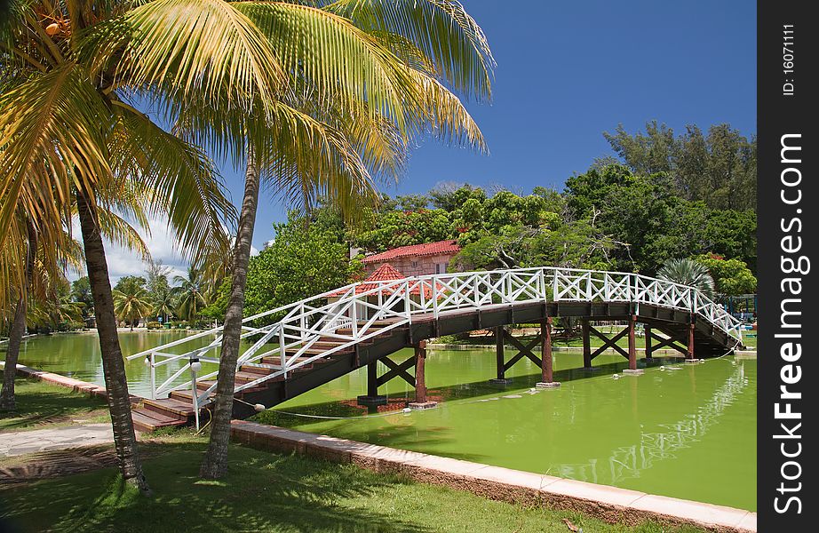 Foot-bridge with reflection in Hesone park, Varadero