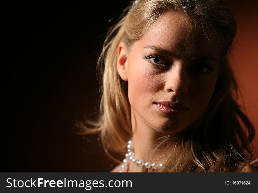 Studio portrait of a blonde lady in dark colours. 5D, 70-200 2.8 L