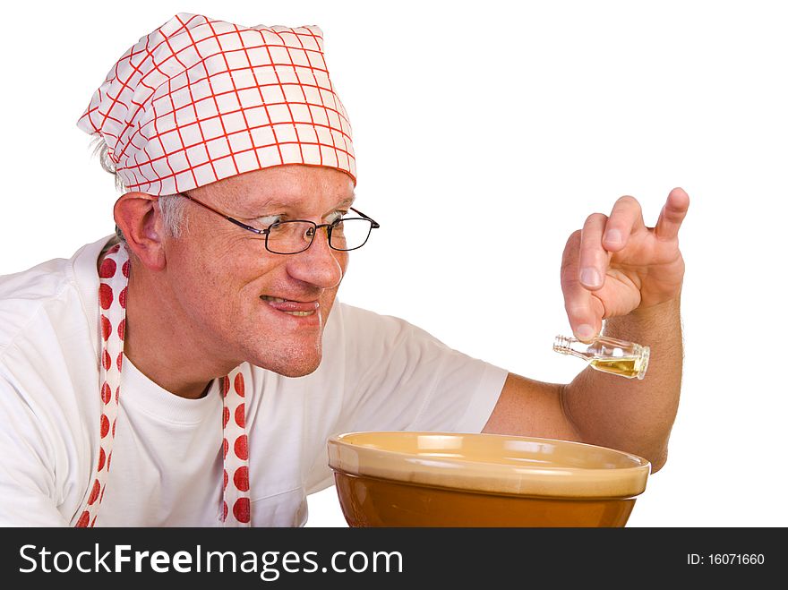 Man pouring a few drops of spice in a bowl
