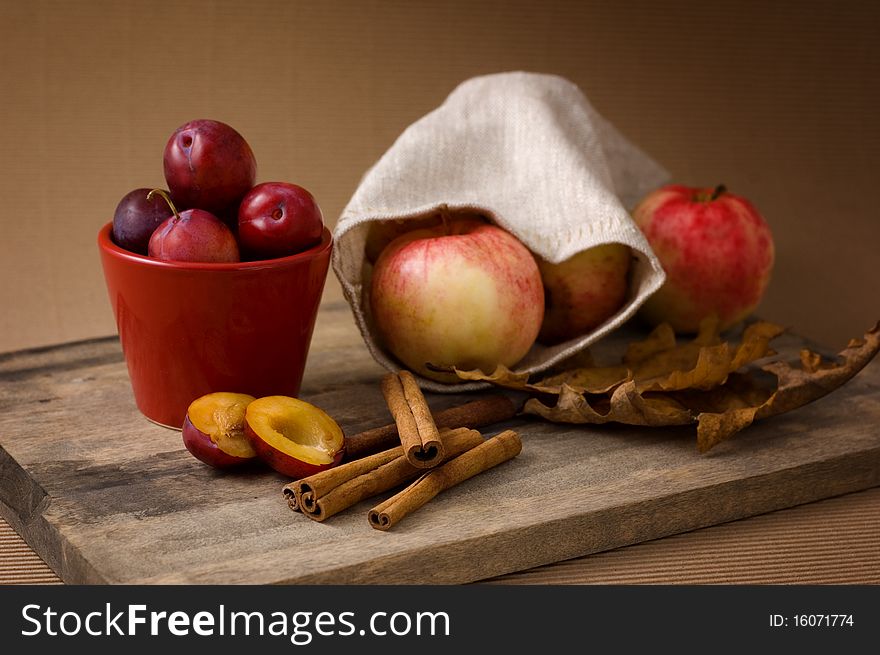 Still-life with apples, plums and cinnamon. Still-life with apples, plums and cinnamon