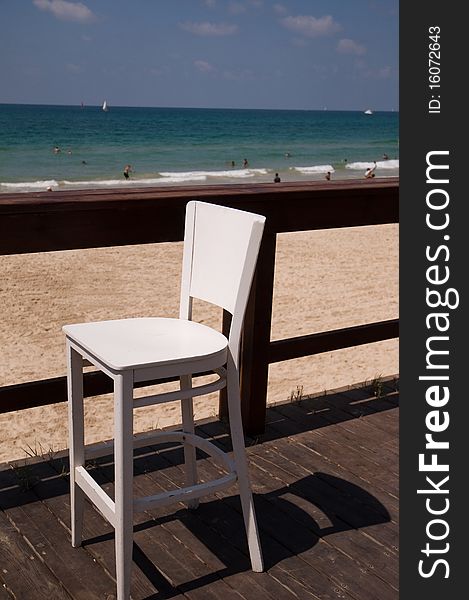 Wooden chairs on a sea view balcony . Wooden chairs on a sea view balcony .