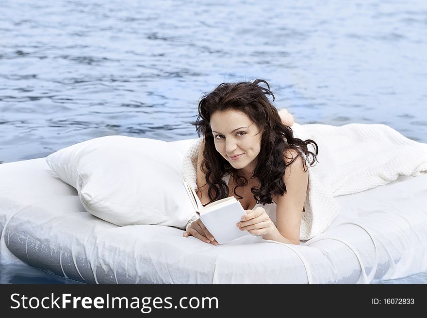 Woman Lying On The Bed In The Sea