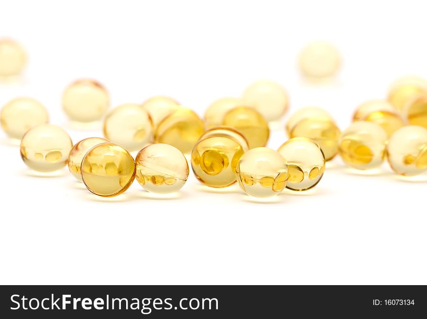 Transparent yellow capsules isolated on white