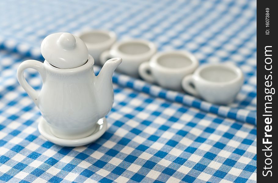 Mini Tea Kettle with Out of Focus Cups in Background