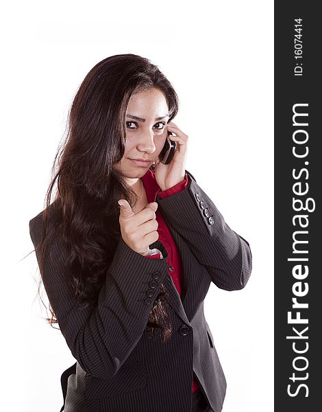 A woman is on her cell phone and pointing her finger. A woman is on her cell phone and pointing her finger.