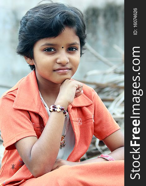 Portrait of Indian Teenage Girl Sitting on a Stone