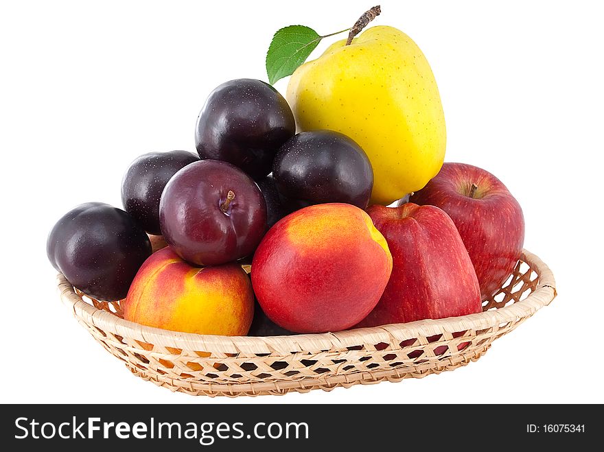 Ripe juicy fruit in a wicker vase isolated on white background