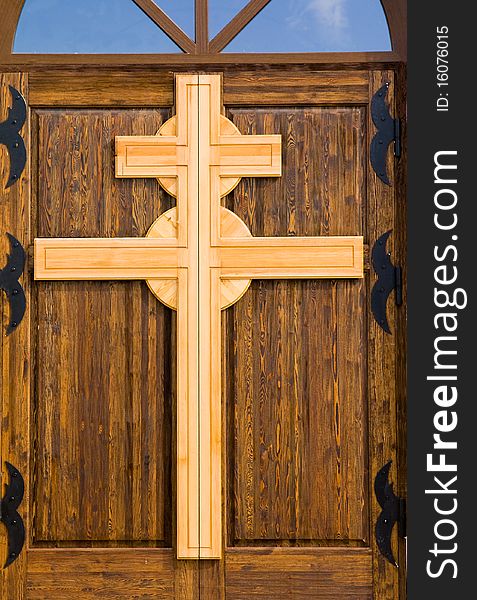 Cross from a tree, being on a door in a temple. Cross from a tree, being on a door in a temple