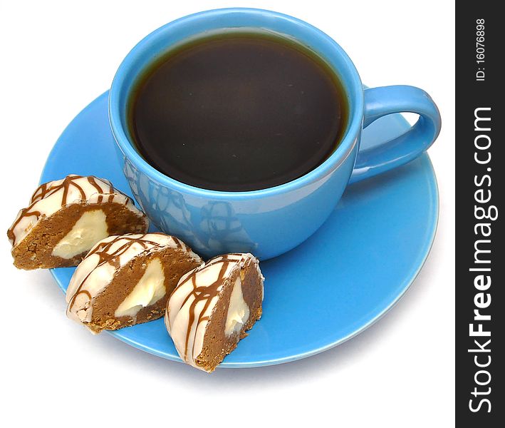 Tea in blue cup, a saucer, cookies