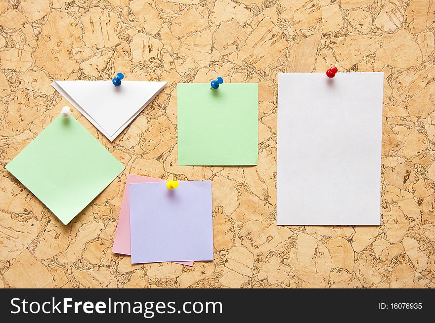 Color sticky notes over brown cork background