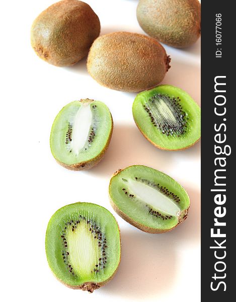 Kiwis cut and whole on a white background