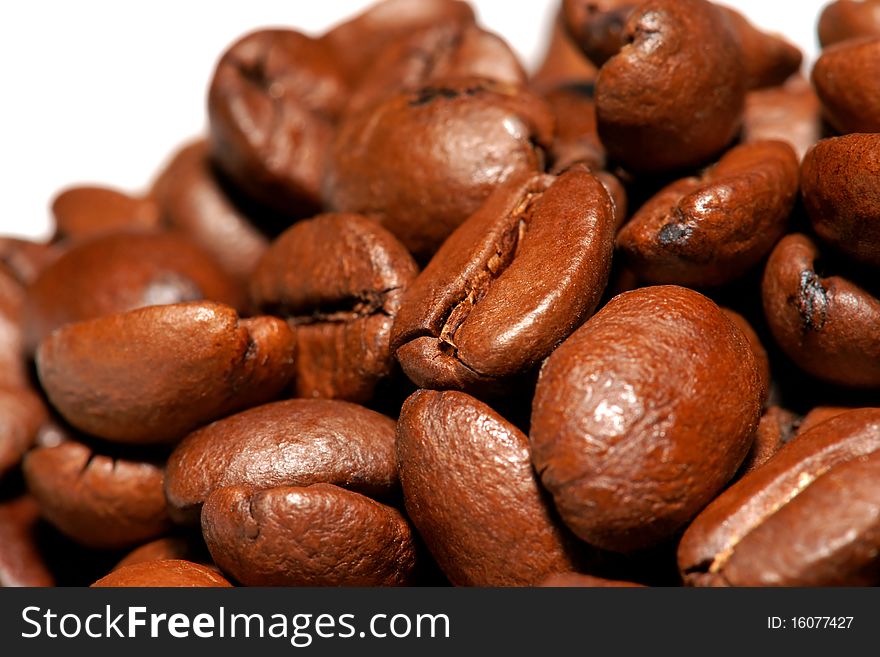 Close up of spilled brown coffee beans. Close up of spilled brown coffee beans