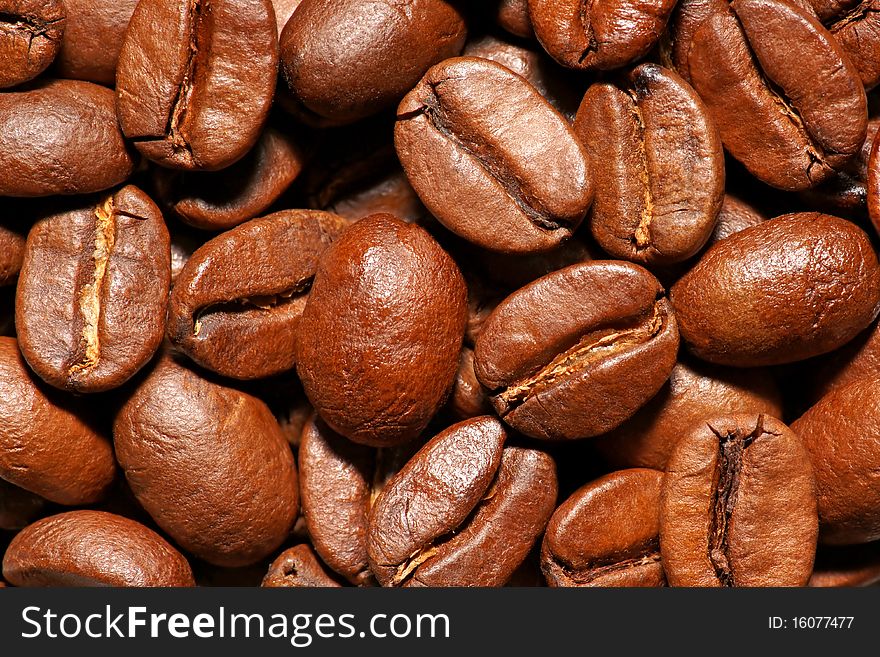 Close up of spilled brown coffee beans. Close up of spilled brown coffee beans