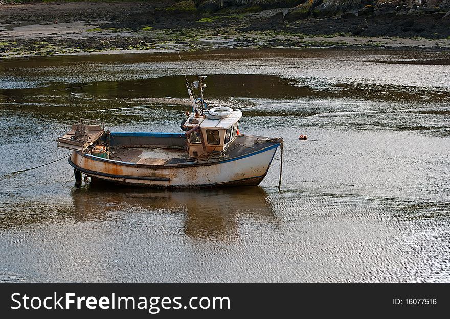 A small fishing boat in the harbour at Milford Haven, Wales.