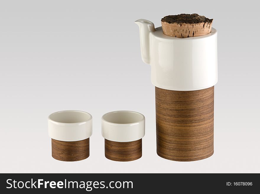 A tea set consisting of a kettle and 2 cups with a unique design