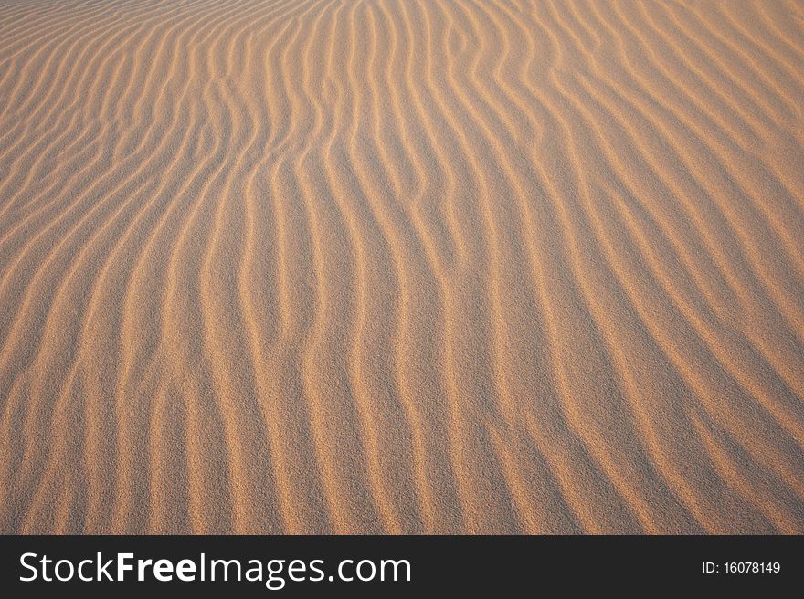 Patterns on a sand dune lit up by sun. Patterns on a sand dune lit up by sun