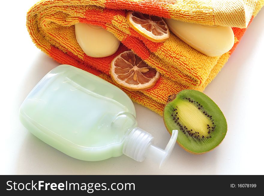 Soft green soap, alongside towel, kiwi, lemon. Soft green soap, alongside towel, kiwi, lemon