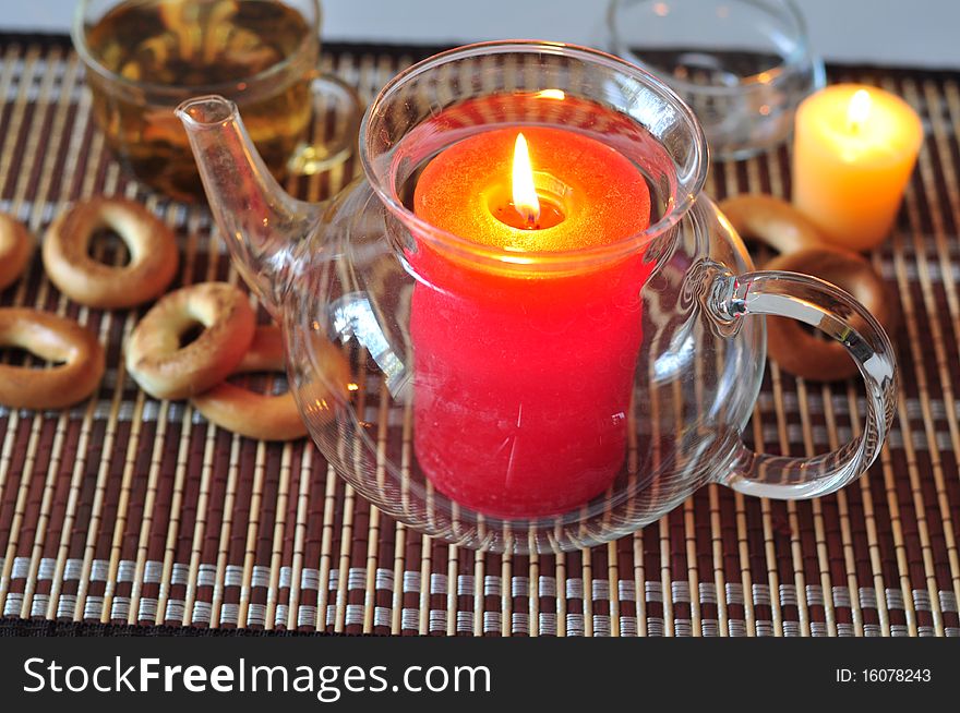 A large red candle burns and yellow little. A large red candle burns and yellow little