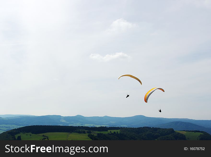 Fun sports: Two colorful paraglider up in the air. Fun sports: Two colorful paraglider up in the air.