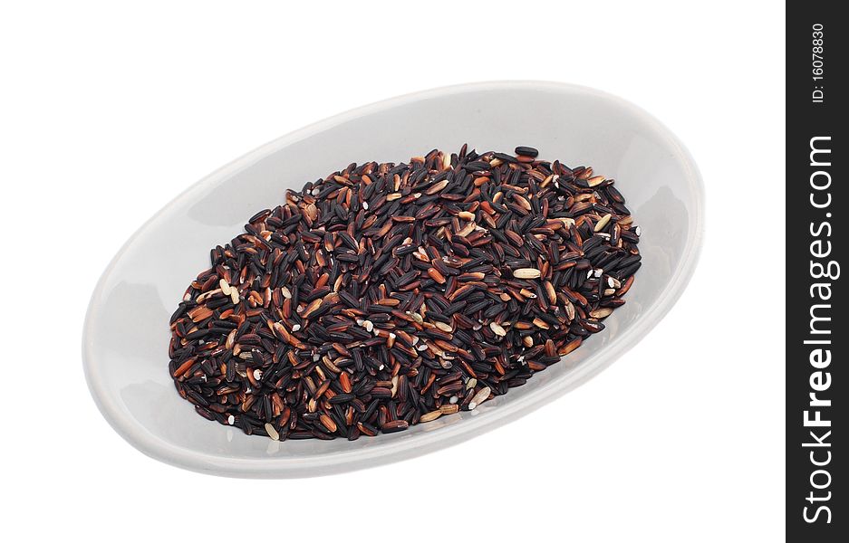 Mixed brown and black rice in dish isolated over white background. Mixed brown and black rice in dish isolated over white background