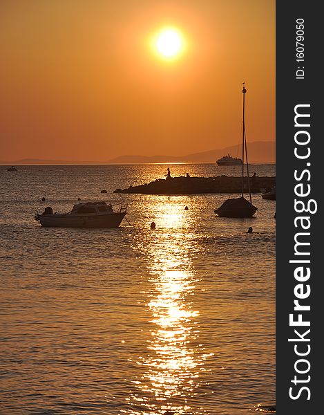 Beautiful sunset and the ships that anchored in the harbor