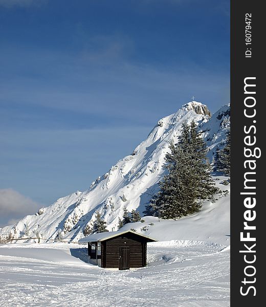 A little shed standing on front of the alps on a sunny winterday. A little shed standing on front of the alps on a sunny winterday