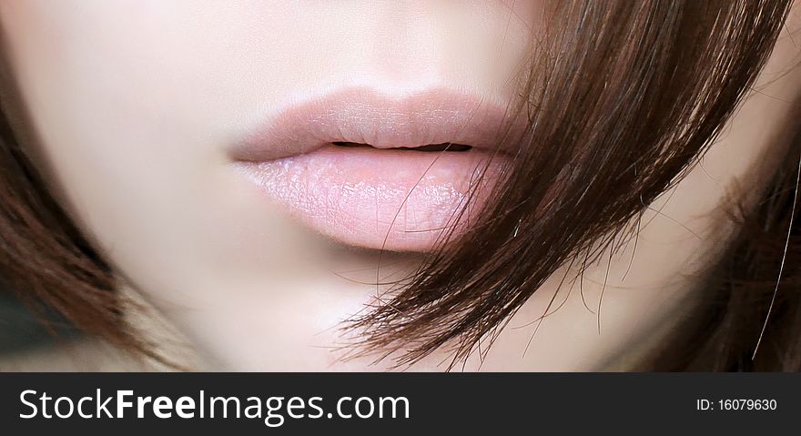 Detail view of a woman's glossy lips