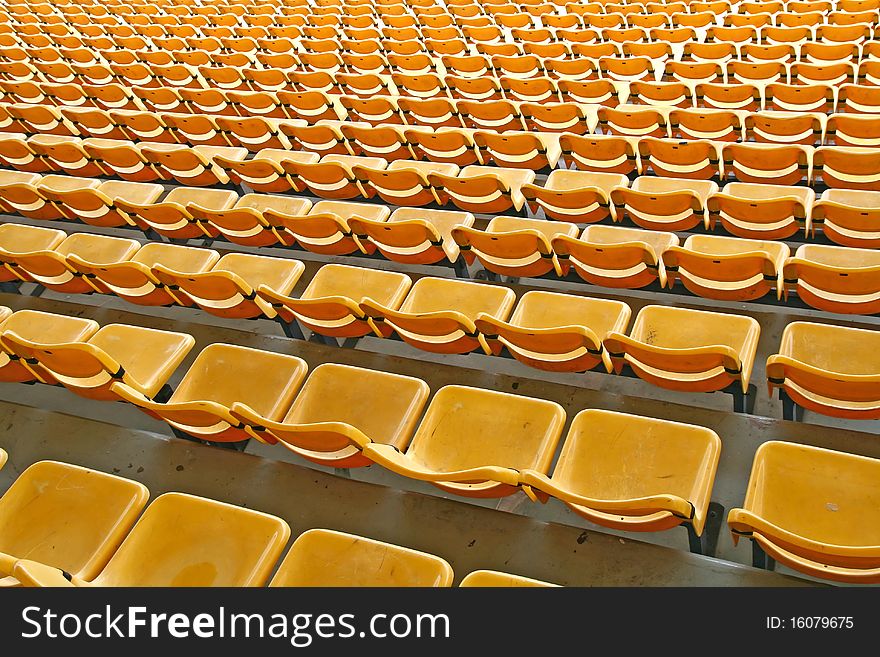 Perspective of yellow seats in football stadium, pattern background